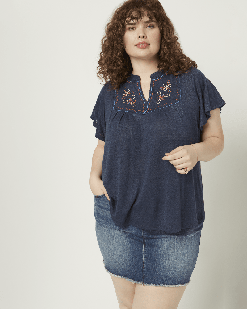 Front of a model wearing a size 1X Caty Embroidered Front Peasant Blouse in Navy by Bobeau. | dia_product_style_image_id:210516